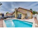 Beautiful backyard pool area with patio seating, ideal for entertaining and enjoying the outdoors at 3320 Haven Beach Way, Las Vegas, NV 89117