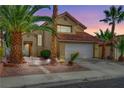 Two-story house with Spanish tile roof, landscaped yard, and two-car garage at 3320 Haven Beach Way, Las Vegas, NV 89117