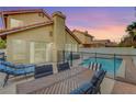 Backyard patio with dining table and chairs, adjacent to the pool at 3320 Haven Beach Way, Las Vegas, NV 89117