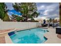 Sparkling backyard pool with a relaxing waterfall feature, perfect for summer days at 3320 Haven Beach Way, Las Vegas, NV 89117
