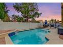 Inviting swimming pool with waterfall feature and patio furniture at 3320 Haven Beach Way, Las Vegas, NV 89117