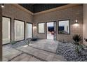 Private courtyard with stone flooring and drought-tolerant landscaping at 37 Reflection Shores Ln, Henderson, NV 89011