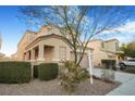 Two-story house with tan exterior, landscaping, and a two-car garage at 3817 Bella Legato Ave, North Las Vegas, NV 89081