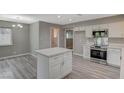 Bright kitchen with white cabinets, stainless steel appliances and an island at 3834 S Sandhill Rd, Las Vegas, NV 89121