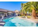 Inviting freeform swimming pool in a lush backyard setting at 5378 Pendini Point Ct, Las Vegas, NV 89141