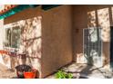 Townhouse entry with security door and potted plants at 6750 Del Rey Ave # 122, Las Vegas, NV 89146