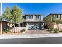 Two-story home with gray exterior, two-car garage, and landscaped yard at 6942 Alexandrite Peak St, Las Vegas, NV 89148