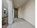 Covered entryway with a dark brown door leading into the home at 7564 Daniel Boone Ct, Las Vegas, NV 89166