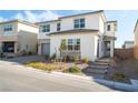 Two-story house with gray garage door and landscaping at 8990 Rolling Pietra St, Las Vegas, NV 89166