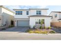 Two-story house with gray garage door and landscaping at 8990 Rolling Pietra St, Las Vegas, NV 89166