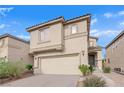 Two-story house with a beige facade and attached garage at 10646 Shifting Breeze Ave, Las Vegas, NV 89129