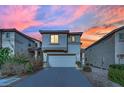 Two-story house with attached garage and landscaping at 10646 Shifting Breeze Ave, Las Vegas, NV 89129