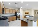 Spacious kitchen featuring wood cabinets, stainless steel appliances, and ample counter space at 2538 Capella Star St, Henderson, NV 89044