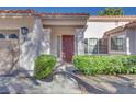 Front entry with red door and sidelights at 256 Garfield Dr, Henderson, NV 89074