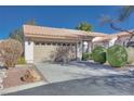 Tan colored stucco home with two-car garage at 256 Garfield Dr, Henderson, NV 89074