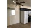 Cozy kitchen with white refrigerator, dark cabinetry, and tile flooring at 2725 S Nellis Blvd # 1201, Las Vegas, NV 89121