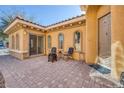 Cozy front patio with brick flooring, seating area, and direct access to the home at 4917 Teal Petals St, North Las Vegas, NV 89081