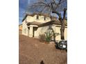 Two-story house with tan exterior, attached garage, and mature tree in front at 6528 Slate Springs Ct, Las Vegas, NV 89122