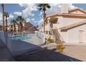 Community pool with surrounding buildings and landscaping at 1013 Falconhead Ln # 101, Las Vegas, NV 89128