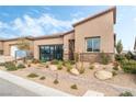 Modern single story home with neutral color palette and well manicured landscaping at 10270 Super Jovian St, Las Vegas, NV 89143