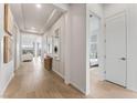 Light and airy hallway with hardwood floors, leading to living areas and bedrooms at 10270 Super Jovian St, Las Vegas, NV 89143