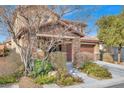 Two-story house with brown accents and landscaping at 10597 Painted Bridge St, Las Vegas, NV 89179