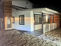 Night view of charming home with updated facade and landscaping at 116 W Victory Rd, Henderson, NV 89015