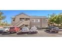 Condo building with parking lot and several cars parked at 2101 Quartz Cliff St # 207, Las Vegas, NV 89117