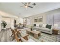 Bright living room featuring contemporary furnishings, neutral paint, light wood flooring, and bright natural light at 2668 Alwoodley Cir, Las Vegas, NV 89142