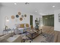 Light-filled living room featuring a neutral color palette and hardwood floors at 3883 Seedling Way, Las Vegas, NV 89115