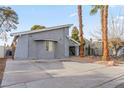 Gray house with palm trees and a gravel yard at 4775 Summerhill Rd, Las Vegas, NV 89121