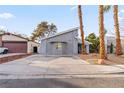 Gray house with palm trees and a paved driveway at 4775 Summerhill Rd, Las Vegas, NV 89121