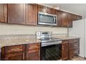 Modern kitchen with granite countertops and stainless steel appliances at 4775 Summerhill Rd, Las Vegas, NV 89121