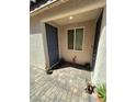 Front entryway with gray door and tile flooring at 6306 Orions Belt Peak St, North Las Vegas, NV 89031