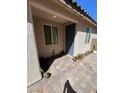 Front entry with gray door, tile flooring, and potted plants at 6306 Orions Belt Peak St, North Las Vegas, NV 89031