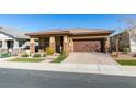 Modern single story home with brown garage door and landscaping at 752 Drammatico Pl, Henderson, NV 89011