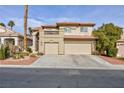 Two-story house with three-car garage and desert landscaping at 9542 Gainey Ranch Ave, Las Vegas, NV 89147