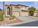 Two-story house with three-car garage and desert landscaping at 9542 Gainey Ranch Ave, Las Vegas, NV 89147