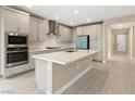 Spacious kitchen with light cabinets, large island, and stainless steel appliances at 9911 Spinel Pl, Las Vegas, NV 89143