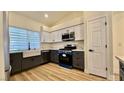 Updated kitchen, featuring white and gray cabinets and quartz countertops at 10173 Grants Arbor Rd, Las Vegas, NV 89183