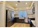 Modern kitchen with stainless steel appliances and white cabinets at 10173 Grants Arbor Rd, Las Vegas, NV 89183