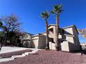 Two-story house with a two-car garage and red rock landscaping at 10488 Beckaville Ave, Las Vegas, NV 89129