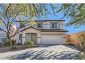 Charming two-story home with a well-maintained front yard and attached two car garage at 11276 Accademia Ct, Las Vegas, NV 89141