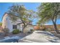 Two-story house with a driveway and landscaping in front at 11276 Accademia Ct, Las Vegas, NV 89141