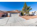 Single-story house with a two-car garage and a well-maintained front yard at 1235 Pagentry Dr, North Las Vegas, NV 89031