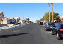 Residential street with parked cars and houses visible at 1235 Pagentry Dr, North Las Vegas, NV 89031