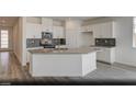 Modern kitchen featuring white cabinetry, stainless steel appliances, gray countertops, and a stylish backsplash at 129 Castanet Ln # Lot 190, Henderson, NV 89015