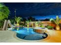 Inviting backyard oasis featuring a sparkling pool, spa, and palm trees at 156 Ozuna Ct, Las Vegas, NV 89183