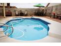 Inviting kidney-shaped pool with a spa and patio furniture at 1972 Weenap Dr, Las Vegas, NV 89108