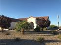 Spanish-style home with desert landscaping and a gravel driveway at 2416 Weaverville Dr, Henderson, NV 89044